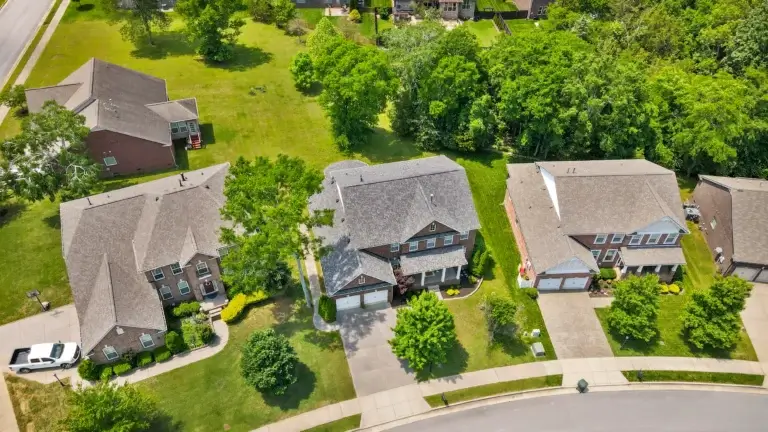 Aerial drone photo of a suburban home in Middle Tennessee with surrounding greenery